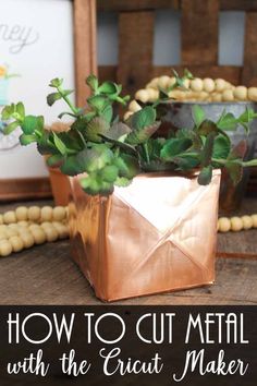 a potted plant sitting on top of a wooden table next to a sign that says, how to cut metal with the cricut maker