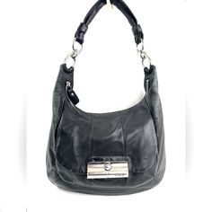 Who Doesn't Luv A Leather Bag You Can Use Everyday And Look Great Doing It? This Coach Kristin 16808 Black Leather Shoulder Bag Will Look Great With Most Of Your Wardrobe. The Front Has A Gusseted Pocket With A Latched Flap And Inside Is A Zipped Pocket And 2 Slip Pockets. Very Good Condition. Minimal Normal Wear. Lots Of Spots Around Inside. No Long Strap. This Is A Pre-Owned Item And May Have Fading Or Discoloration, Marks Or Stains, Scratches, Wrinkling, Wear On Straps, Trim And Texture. If T Coach Business Shoulder Bag With Branded Hardware, Classic Black Hobo Bag With Metal Hardware, Coach Hobo Bag With Silver-tone Hardware For Daily Use, Coach Hobo Shoulder Bag With Silver-tone Hardware, Coach Hobo Shoulder Bag With Branded Hardware, Coach Satchel With Snap Closure, Formal Black Hobo Bag With Metal Hardware, Coach Satchel Shoulder Bag With Metal Hardware, Coach Black Shoulder Bag With Metal Hardware