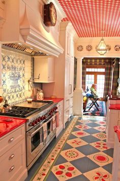 the kitchen is decorated in red and white