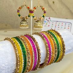 The perfect gift for Mehndi, Eid or special occasion! This gift box contains bangle set, earring and bindi pack.  2 small half stacks of beautiful multicoloured  bangles with pearl detail.  See our bangle size chart, measured 1.5 inch length each arm.    Stunning lightweight jhumka hoop earrings 2.5 inch length x 1.75 inch wide A pack of small colourful bindis! Ready to ship! Festive Adjustable Earrings For Gifts, Festive Gift Earrings, Handmade Bollywood Bangle For Celebration, Handmade Bollywood Style Bangle For Celebration, Bollywood Style Handmade Bangle For Celebration, Handmade Bangle As Diwali Gift, Handmade Bangle As A Diwali Gift, Handmade Bangle For Diwali Gift, Adjustable Meenakari Bangle As Gift