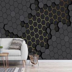 a modern living room with black and gold hexagonal wallpaper, a white couch and coffee table