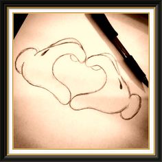 a drawing of a heart on paper with a pen