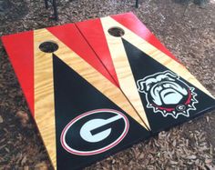 two black and red cornhole boards sitting on the ground