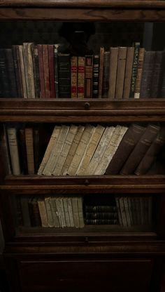 an old bookcase with many books on it