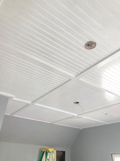 the ceiling in this room is white and has no curtains on it, as well as a light fixture