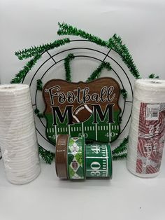 the football mom gift set includes two cups and three rolls of toilet paper as well as a wooden sign