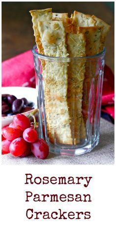 rosemary parmesan crackers in a glass with grapes and cherries on the side