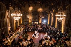 a bride and groom walk down the aisle at their wedding reception in an ornate building