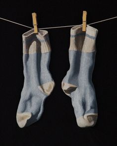 two pairs of socks hanging on a clothes line