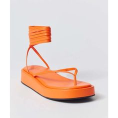 Urban Outfitters Jaida Platform Tie Up Thong Sandal In Orange Orange Single Toe Strap Sandals For Spring, Orange Toe Post Sandals For Summer, Spring Vacation Lace-up Toe Loop Sandals, Spring Vacation Toe Loop Lace-up Sandals, Summer Platform Flip Flops With Single Toe Strap, Spring Platform Sandals With Toe Loop, Toe Loop Wedge Sandals For Vacation In Spring, Toe Loop Wedge Sandals For Spring Vacation, Trendy Urban Outfitters Summer Sandals