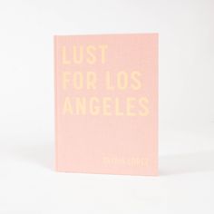 a pink book with the words lust for los angeles printed on it's cover