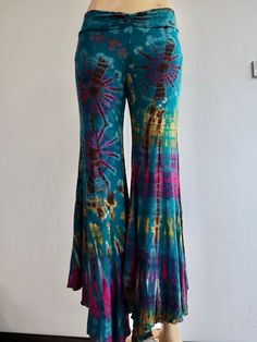 "Handmade Materials: Cotton, Lycra Description These tie dye splatter bell bottoms are made for movement! Perfect for yoga and flow activities. Handmade and hand-dyed, available from a variety of 4 colour ways to choose from 🌸 The fitting around the thigh is flattering & shaping until the material billows out at the knee into a wide flare. Featuring drawstrings on either side of the thigh that can be cinched for shape and length adjustment! The material consists of a quality Rayon 95% spandex 5 Hippie Full-length Pants For Fall, Hippie Full Length Pants For Fall, Hippie Style Full Length Pants For Fall, Bohemian Flare Bottoms For Fall, Bohemian Style Flare Bottoms For Fall, Fall Hippie Pants, Hippie Full Length Bottoms For Fall, Hippie Style Full-length Bottoms For Fall, Hippie Style Full Length Bottoms For Fall