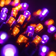 purple and yellow lights are lit up in the dark, as if they were floating or floating