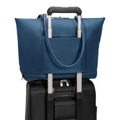 Surprisingly roomy for such a sleek silhouette, this tote expands and is designed with thoughtful compartments and pockets to transport everything from your laptop to your travel essentials gym clothes—while making it all easy to grab on the go. Fits up to a 13" laptop. SKU: PT225X-5 Laptop Compartment Slip-Through Back Panel INTERIOR FEATURES Bottom zippered expansion that adds 4" of packing capacity when you need it. Cavernous main compartment holds an assortment of items both large and small. Internal organizer with two slip pockets, business card slip pockets, and pen loops. Keep your water bottle secure but accessible with an interior pocket. Tech section in main compartment includes an integrated padded laptop sleeve protects most 15" computers and slip pocket for a tablet. Fabric li Leather Fob, Luxury Luggage, Monogram Luggage, Gift Guide Women, Briefcase Women, Cabin Bag, Luggage Brands, Stationary Gifts, Checked Luggage