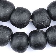 some black fruit on a white background