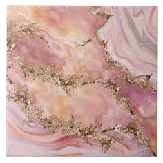 an abstract painting with gold and pink colors on the marble surface is featured in this image