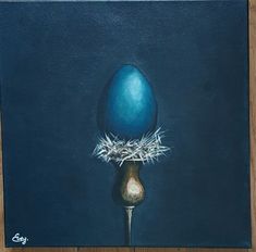 a painting of an egg sitting on top of a metal vase with hay in it