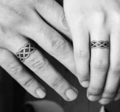 two people with wedding rings on their fingers, one holding the other's hand