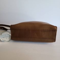 "Vtg Coach Original Swagger Bag Tan leather with brass hardware Roomy interior with inner slip pocket secured with a top zipper. 2 full size slip pockets on both sides Adjustable 44\" shoulder strap Measures: 11.5\"L, 7\"H, 4\"W Made in the United States #058-3006 Cleaned, conditioned and ready to wear! Questions? Just ask More vtg coach styles/colors also available G4" Rectangular Travel Shoulder Bag With Brass Hardware, Rectangular Shoulder Bag With Brass Hardware For Travel, Leather Shoulder Bag With Brass Hardware For Travel, Leather Bucket Shoulder Bag With Brass Hardware, Travel Bucket Bag With Brass Hardware, Travel Satchel With Brass Hardware And Tote Shape, Classic Bags With Brass Hardware For On-the-go, Travel Satchel With Brass Hardware Tote, Travel Satchel With Brass Hardware