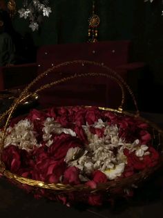 a basket filled with red and white flowers