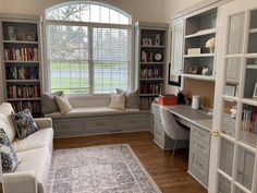 a living room filled with furniture and bookshelves