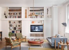 a living room filled with furniture and bookshelves