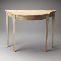 an oval wooden table with two legs and a curved design on the top, against a gray background