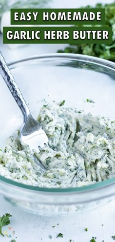 homemade garlic herb butter in a glass bowl with a silver spoon and parsley on the side