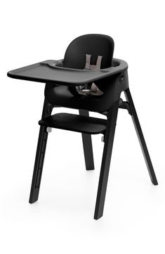 a black high chair with a baby seat on it's back and the seat up