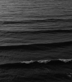 a person riding a surfboard on top of a wave in the middle of the ocean