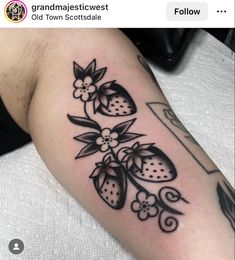 a black and white tattoo with strawberries on it