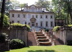 an old mansion with steps leading up to it