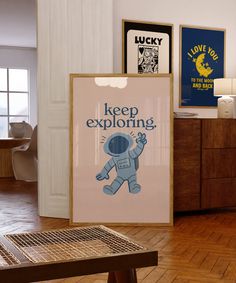 there is a sign that says keep exploring on the wall next to a wooden table