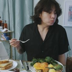 a woman sitting at a table with food in front of her