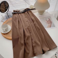 Style: commuting Size: one size Color: coffee, apricot, khaki, black, blue Chic Brown Midi Length Skirt, Chic Solid Color Midi Pleated Skirt, Chic Midi Pleated Skirt In Solid Color, Chic Solid Color Pleated Midi Skirt, Brown Pleated Midi Skirt For Work, Relaxed Fit Brown Skirt, Chic Brown A-line Skirt, Chic Fall Pleated Skirt In Solid Color, Casual Brown Solid Color Skirt