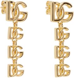 Pair of drop earrings in gold-tone brass. · Logo hardware at face and drop · Post-stud fastening · H1.25 x W0.5 Supplier color: Gold Designer Gold Drop Earrings, Designer Gold-tone Logo Plaque Earrings For Formal Occasions, Designer Gold-tone Metal Earrings, Designer Yellow Gold Jewelry With Logo Lettering, Designer Gold Drop Clip-on Earrings, Designer Gold-tone Clip-on Earrings, Luxury Gold-tone Earrings With Logo Plaque, Luxury Gold-tone Dangle Earrings, Ornate Dual-tone Gold Earrings