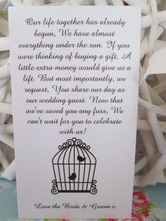 a white card with an image of a bird in a cage on it's side