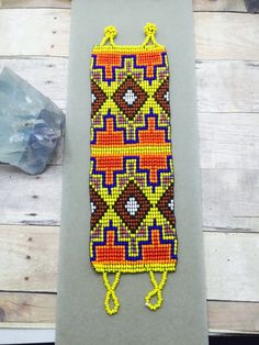 a beaded phone case sitting on top of a table