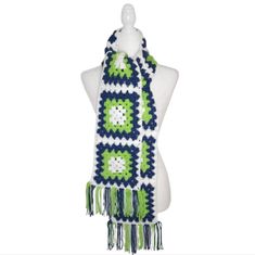 a white mannequin wearing a green and blue scarf