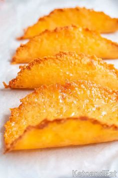 three pieces of fried food sitting on top of white paper