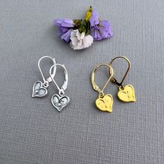 ✦These cute, dainty earrings make a great gift for a daughter, best friend or girlfriend. Tiny heart charms dangle from sturdy leverback or French hook ear wires. ✦ Heart charms: sterling silver or 14k gold vermeil (gold plated over sterling silver), 15mm in diameter, with a polished surface, measuring 9mm x 9mm, (3/8" x 3/8"). ✦Ear wires: sterling silver or 14k gold-filled, select from either French hook or leverback style.  ✦Length of earring is 7/8". ✦Your jewelry will be packaged in a beautiful and reusable organza bag. All items will be placed in the same organza bag. If you need a separate bag for each item, please leave a comment at check out. ✦Giving your purchase as a gift? If you would prefer that prices not be printed on your invoice, please check "this item is a gift".  ✦To rec Dainty Dangle Heart Earrings For Everyday, Dainty Hypoallergenic Huggie Heart Earrings, Gold Sterling Silver Earrings With Heart Charm, Dainty Heart Charm Earrings For Everyday, Gold Hypoallergenic Heart Earrings In Sterling Silver, Gold Sterling Silver Heart Earrings For Everyday, Gold Sterling Silver Hypoallergenic Heart Earrings, Everyday Gold Heart Earrings In Sterling Silver, Nickel Free Dangle Heart Earrings For Anniversary