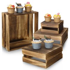 three wooden boxes with cupcakes on them