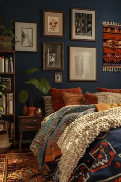 a bed room with a neatly made bed and lots of pictures on the wall above it