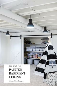 an old salt farm painted basement ceiling with black and white striped tent in the corner