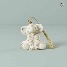 an elephant ornament with a tassel hanging from it's back