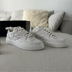 Brand-New Chanel White Calfskin Sneakers From 2023 Collection, Eu Size 36.5 (Fits Like A 36 As They Run Small). Your Purchase Includes The Original Box, Extra Laces, And Dust Bag. Any Questions? Reach Out Before Purchasing. Enjoy Poshing! Luxury White Sole Sneakers With Laces, Chic Sneakers With Perforated Toe Box, Luxury Sneakers With Rubber Sole, Designer Calf Leather Sneakers With Round Toe, Luxury Calf Leather Sneakers, Luxury Calf Leather Sneakers For Streetwear, Chic Leather Sneakers For Streetwear, Chic Sneakers With Leather Sole And Round Toe, Chic Leather Sneakers With Leather Sole