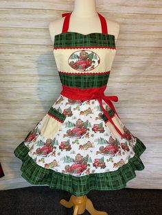 a dress made to look like an apron with cars on it and red ribbon around the waist