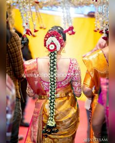 a woman in a sari walking down the aisle