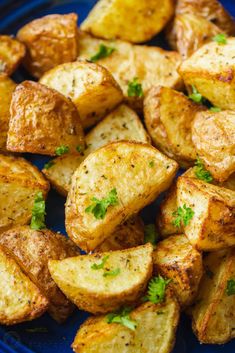 cooked potatoes with parsley on a blue plate