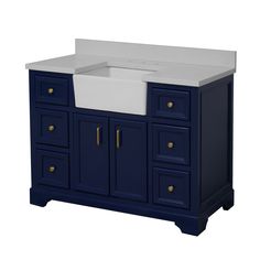 a white sink sitting on top of a blue cabinet next to a counter with drawers